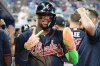 Atlanta Braves' Ronald Acuna reacts after scoring on a RBI single hit by Matt Olson during the eighth inning of a baseball game against the Miami Marlins, Tuesday, May 19, 2026, in Miami. (AP Photo/Lynne Sladky)