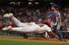 Washington Nationals' James Wood slides into home as New York Mets catcher Luis Torrens waits for the throw on an inside the park gland slam home run during the second inning of a baseball game Tuesday, May 19, 2026, in Washington. (AP Photo/John McDonnell)