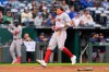 Boston Red Sox's Jarren Duran runs home to score on a single by Willson Contreras during the first inning of a baseball game against the Kansas City Royals, Tuesday, May 19, 2026, in Kansas City, Mo. (AP Photo/Charlie Riedel)