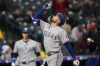 Texas Rangers' Brandon Nimmo gestures as he crosses home plate after hitting a two-run home run off Colorado Rockies relief pitcher Tanner Gordon in the fourth inning of a baseball game Tuesday, May 19, 2026, in Denver. (AP Photo/David Zalubowski)