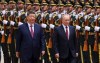 Russian President Vladimir Putin, right, and Chinese President Xi Jinping inspect an honor guard during a welcoming ceremony at the Great Hall of the People in Beijing Wednesday, May 20, 2026. (Maxim Shemetov/Pool Photo via AP)