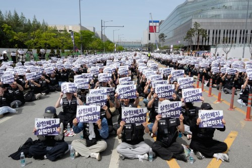 Members of the Samsung Electronics labor union hold up their cards during a rally demanding higher bonuses at its computer chip complex in Pyeongtaek, South Korea, Thursday, April 23, 2026. The letters read 