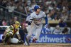 Los Angeles Dodgers' Shohei Ohtani watches his double during the eighth inning of a baseball game against the San Diego Padres Tuesday, May 19, 2026, in San Diego. (AP Photo/Gregory Bull)