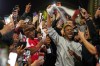 Former Arsenal player Ian Wright celebrates with Arsenal supporters at the Arsenal stadium after Arsenal's soccer team won the Premier League title in London, Tuesday, May 19, 2026.(AP Photo/Alberto Pezzali)