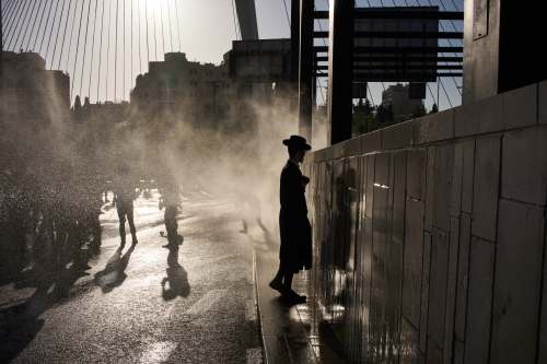 Police use a water cannon to disperse ultra-Orthodox Jewish men blocking a street during a protest against army recruitment in Jerusalem, Wednesday, April 29, 2026. (AP Photo/Leo Correa)
