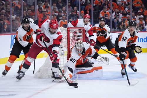 Carolina Hurricanes' William Carrier (28) tries to get the puck past Philadelphia Flyers' Dan Vladar (80), Trevor Zegras (46) and Jamie Drysdale (9) during the third period of Game 4 in a second-round NHL hockey Stanley Cup playoff series Saturday, May 9, 2026, in Philadelphia. (AP Photo/Matt Slocum)