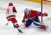 Canadiens goaltender Jakub Dobes (75) stops Carolina Hurricanes winger Taylor Hall (71) on a breakaway in Montreal on Tuesday, March 24, 2026. THE CANADIAN PRESS/Christinne Muschi