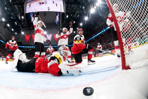 Switzerland's Nico Hischier, right, scores the fifth goal to Austria's goaltender David Kickert, left, during the 2026 IIHF Men's Ice Hockey World Championship preliminary round group A game between Austria and Switzerland, in Zurich, Switzerland, Wednesday, May 20, 2026. (Claudio Thoma/Keystone via AP)