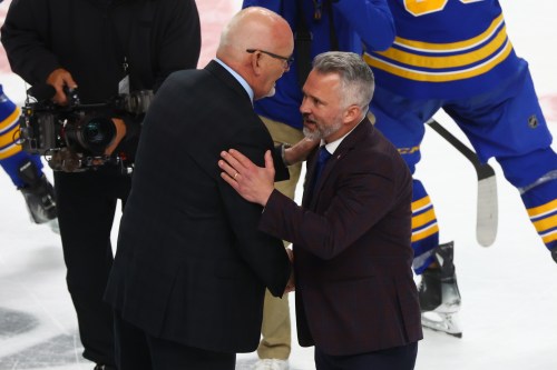 Buffalo Sabres head coach Lindy Ruff, left, and Montreal Canadiens head coach Martin St. Louis, right, shake hands following the overtime period in Game 7 of a second-round NHL hockey Stanley Cup playoff series Monday, May 18, 2026, in Buffalo, N.Y. (AP Photo/Jeffrey T. Barnes)