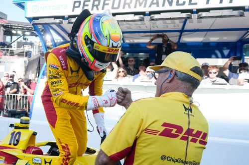 Alex Palou, of Spain, celebrates with a member of his crew during qualifications for the Indianapolis 500 auto race at the in Indianapolis, Sunday, May 17, 2026. (AP Photo/Michael Conroy)