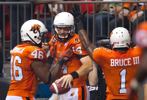 B.C. Lions' Rolly Lumbala, from left, quarterback Travis Lulay and Arland Bruce III celebrate Lulay's touchdown against the Winnipeg Blue Bombers during the first half of a CFL football game in Vancouver, B.C., on Friday, June 29, 2012. THE CANADIAN PRESS/Darryl Dyck