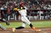 Arizona Diamondbacks' Geraldo Perdomo watches the flight of his two-run double against the San Francisco Giants during the fifth inning of a baseball game, Wednesday, May 20, 2026, in Phoenix. (AP Photo/Ross D. Franklin)