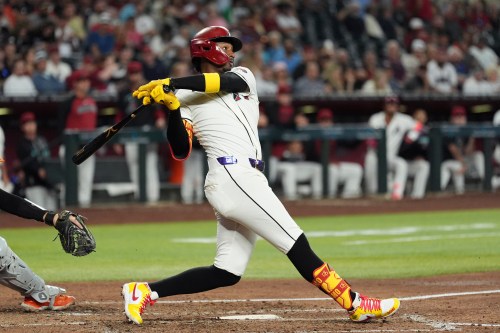 Arizona Diamondbacks' Geraldo Perdomo watches the flight of his two-run double against the San Francisco Giants during the fifth inning of a baseball game, Wednesday, May 20, 2026, in Phoenix. (AP Photo/Ross D. Franklin)
