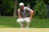 Scottie Scheffler lines up his shot on the first green during the final round of the PGA Championship golf tournament at Aronimink Golf Club, Sunday, May 17, 2026, in Newtown Square, PA. (AP Photo/Carolyn Kaster)