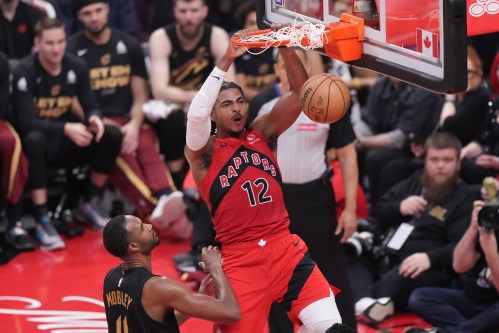 Toronto Raptors forward Collin Murray-Boyles (12) dunks as Cleveland Cavaliers centre Evan Mobley (4) looks on during first half NBA playoff basketball action in Toronto on Sunday, April 26, 2026. THE CANADIAN PRESS/Nathan Denette