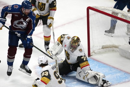 Vegas Golden Knights goaltender Carter Hart, right, stops a shot off the stick of Colorado Avalanche left wing Gabriel Landeskog during the third period in Game 1 of the Western Conference finals NHL hockey Stanley Cup playoff series Wednesday, May 20, 2026, in Denver. (AP Photo/David Zalubowski)