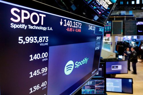 The logo for Spotify appears above the post where it trades on the floor of the New York Stock Exchange on Wednesday, April 4, 2018. (AP Photo/Richard Drew)