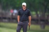 Brooks Koepka smiles while standing on the ninth green during of the first round of the Byron Nelson golf tournament in McKinney, Texas, Thursday, May 21, 2026. (AP Photo/LM Otero)