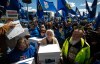 Supporters carry boxes of signatures to submit for a separation referendum to Elections Alberta in Edmonton, on Monday, May 4, 2026. THE CANADIAN PRESS/Jason Franson