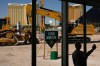 FILE - A person takes a picture near construction equipment during a groundbreaking ceremony for the Athletics' baseball stadium, June 23, 2025, in Las Vegas. (AP Photo/John Locher, File)