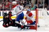 Montréal Canadiens' Mike Matheson (8) takes out Carolina Hurricanes' Taylor Hall (71) in front of Canadiens goaltender Jakub Dobes (75) during the second period in Game 1 of the Eastern Conference finals NHL hockey Stanley Cup playoffs series in Raleigh, N.C., Thursday, May 21, 2026. (AP Photo/Karl DeBlaker)