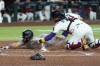 Arizona Diamondbacks catcher Gabriel Moreno, right, tags out Colorado Rockies' Ezequiel Tovar at home plate during the fifth inning of a baseball game, Thursday, May 21, 2026, in Phoenix. (AP Photo/Ross D. Franklin)