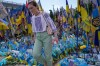 A woman looks at a makeshift memorial for fallen soldiers in Russia Ukraine war on Independence Square in Kyiv, Ukraine, Friday, May 22, 2026. (AP Photo/Efrem Lukatsky)