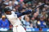 FILE - Seattle Mariners' Victor Robles hits an RBI double against the Cleveland Guardians during the second inning of a baseball game, March 28, 2026, in Seattle. (AP Photo/Lindsey Wasson, File)