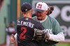 Former Boston Red Sox pitcher Roger Clemens, right, embraces his son, left, Minnesota Twins' Kody Clemens (2), after throwing out a ceremonial first pitch prior to a baseball game between the teams Friday, May 22, 2026, in Boston. (AP Photo/Charles Krupa)