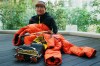Naoko Watanabe, who has become the first Japanese woman to scale all 14 of the world's mountains that reach 8,000m above sea level, poses for a photo with her climbing clothes and gear after an interview with The Associated Press in Tokyo, Wednesday, April 8, 2026. (AP Photo/Hiro Komae)