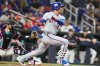 New York Mets' Juan Soto hits a single during the fourth inning of a baseball game against the Miami Marlins, Friday, May 22, 2026, in Miami. (AP Photo/Lynne Sladky)