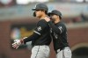 Chicago White Sox's Munetaka Murakami, left, stands at first base with first base coach Jose Leger after Murakami was hit by a pitch during the fourth inning of a baseball game against the San Francisco Giants Friday, May 22, 2026, in San Francisco. (AP Photo/Jeff Chiu)