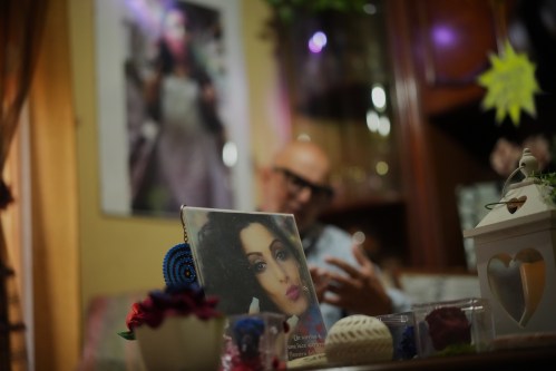 Angelo Venturato talks during an interview with the Associated Press next to photos of his daughter Maria who died at the age of 25 of a cancer he claims to be connected to decades of pollution from illegal waste dumping and burning, much of it linked to organized criminal groups, in the southern town of Acerra, Friday, May 22, 2026. (AP Photo/Andrew Medichini)