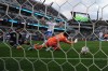 Vancouver Whitecaps FC forward Brian White, left, scores a goal past San Diego FC goalkeeper CJ Dos Santos (1) as defender Christopher McVey (97) looks on during the first half of an MLS soccer match Saturday, May 23, 2026, in San Diego. (AP Photo/Gregory Bull)