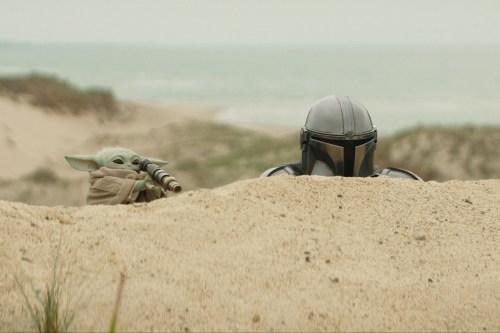 This image released by Disney shows The Mandalorian, portrayed by Pedro Pascal, right, and Grogu in a scene from Lucasfilm's 