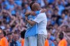 Manchester City's head coach Pep Guardiola hugs Manchester City's Bernardo Silva as he played last match for the team during a Premier League soccer match between Manchester City and Aston Villa in Manchester, England, Sunday, May 24, 2026. (AP Photo/Alastair Grant)