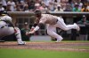 San Diego Padres' Ty France, right, slides into home before being tagged out by Athletics catcher Jonah Heim, let, as France was trying to score from first off a double by Fernando Tatis Jr. during the fifth inning of a baseball game Sunday, May 24, 2026, in San Diego. (AP Photo/Gregory Bull)