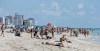 FILE - In this Aug. 2, 2017, file photo, local residents and tourists enjoy a day at the beach in the South Beach area of Miami Beach, Fla. (AP Photo/Alan Diaz, File)