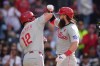 Philadelphia Phillies' Brandon Marsh, right, celebrates with teammate Kyle Schwarber after hitting a two-run home run during the seventh inning of a baseball game against the San Diego Padres Monday, May 25, 2026, in San Diego. (AP Photo/Gregory Bull)