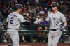 Colorado Rockies' TJ Rumfield celebrates with Tyler Freeman (2) after hitting a solo home run against the Arizona Diamondbacks in the eighth inning of a baseball game, Saturday, May 23, 2026, in Phoenix. (AP Photo/Rick Scuteri)