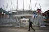 A man walks past fencing surrounding B.C. Place for the FIFA World Cup 2026, in Vancouver on Monday, May 25, 2026. THE CANADIAN PRESS/Ethan Cairns