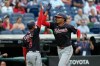 Washington Nationals' James Wood, right, gets a high five from third base coach Victor Estevez (7) as he runs the bases after hitting a home run in the second inning of a baseball game against the Cleveland Guardians in Cleveland, Tuesday, May 26, 2026. (AP Photo/Sue Ogrocki)