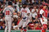 Atlanta Braves' Michael Harris II, center, is congratulated by Mike Yastrzemski (18) after his two-run home run, as Boston Red Sox's Mickey Gasper (30) waits for play to resume, during the eighth inning of a baseball game, Tuesday, May 26, 2026, in Boston. (AP Photo/Charles Krupa)