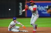 Cincinnati Reds' Elly de la Cruz, right, throws out New York Mets' Mark Vientos at first base after forcing out A.J. Ewing for a double play during the sixth inning of a baseball game Tuesday, May 26, 2026, in New York. (AP Photo/Frank Franklin II)