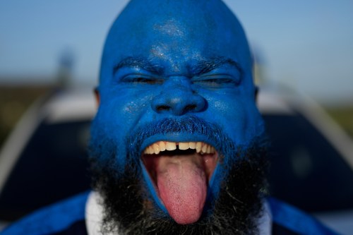 Brenton Balentien, known as Blue Face, a leader of soccer fans of Curacao's national soccer team, cheers in Willemstad, Saturday, May 16, 2026. (AP Photo/Matias Delacroix)