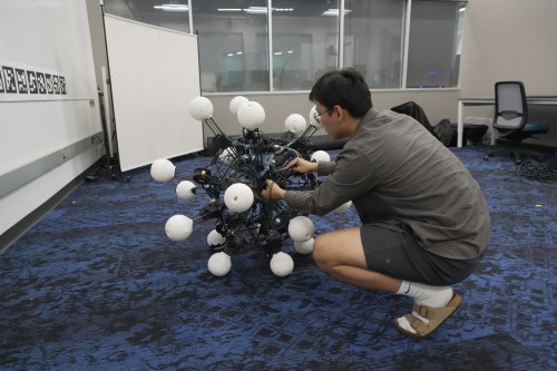 Jiaxun Liu, a Ph.D. student, works on a robot named Argus at Duke University's General Robotics Lab in Durham, N.C., Tuesday, May 26, 2026. (AP Photo/Allen G. Breed)