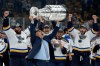FILE - St. Louis Blues coach Craig Berube carries the Stanley Cup after the Blues defeated the Boston Bruins in Game 7 of the NHL Stanley Cup Final in Boston, June 12, 2019. (AP Photo/Michael Dwyer, File)