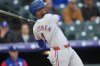 Texas Rangers' Andrew McCutchen flies out against Colorado Rockies starting pitcher Jose Quintana in the first inning of a baseball game Monday, May 18, 2026, in Denver. (AP Photo/David Zalubowski)