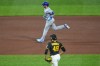 Chicago Cubs' Ian Happ, top, rounds the bases after hitting a three-run home run off Pittsburgh Pirates pitcher Yohan Ramírez (49) during the seventh inning of a baseball game in Pittsburgh, Wednesday, May 27, 2026. (AP Photo/Gene J. Puskar)