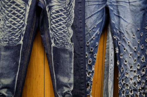 Patterns and distressing, made by a laser, are displayed at the BPD Washhouse, a denim processing facility, in Jersey City, N.J., Tuesday, May 5, 2026. (AP Photo/Seth Wenig)